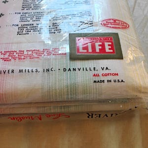 May include: A packaged set of Dan River Mills, Inc. all-cotton bed linens. The packaging includes the text "LIFE" in a red and white box. The packaging also includes the text "MADE IN U.S.A."
