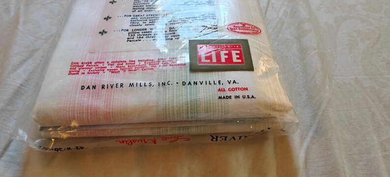 May include: A packaged set of Dan River Mills, Inc. all-cotton bed linens. The packaging includes the text "LIFE" in a red and white box. The packaging also includes the text "MADE IN U.S.A."