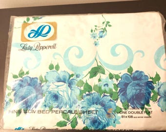 May include: A Lady Pepperell fine combed bed percale sheet in a white package with blue floral patterns and green leaves. The text reads Lady Pepperell, Fine Combed Bed Percale Sheet, 100% Combed Cotton, One Double Flat, 81x108 inches.
