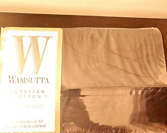 May include: A packaged Wamsutta flat sheet made of Egyptian cotton. The packaging features a large letter W, the brand name Wamsutta, and text stating Egyptian Cotton, Flat Sheet, and 100% Egyptian Cotton with a 300 thread count.