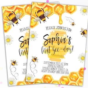 May include: Two invitations with a watercolor design for a "first bee-day" party. The invitations feature a honeycomb pattern, bees, and daisies. The text reads "Please join us for Sophia's first bee-day!" with event details.