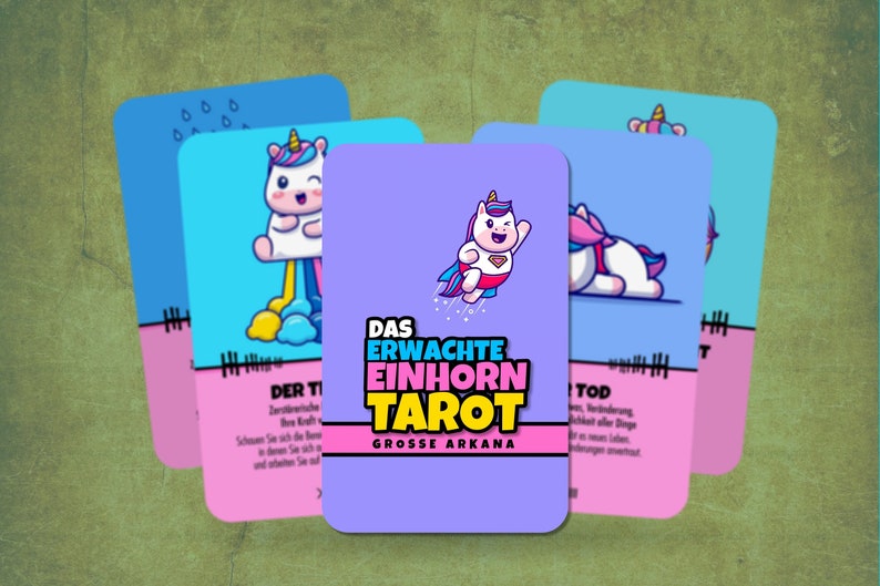 May include: A set of tarot cards featuring a unicorn theme. The cards are purple, pink, and blue with illustrations of unicorns in various poses. The text on the cards reads "Das Erwachte Einhorn Tarot" and "Grosse Arkana".