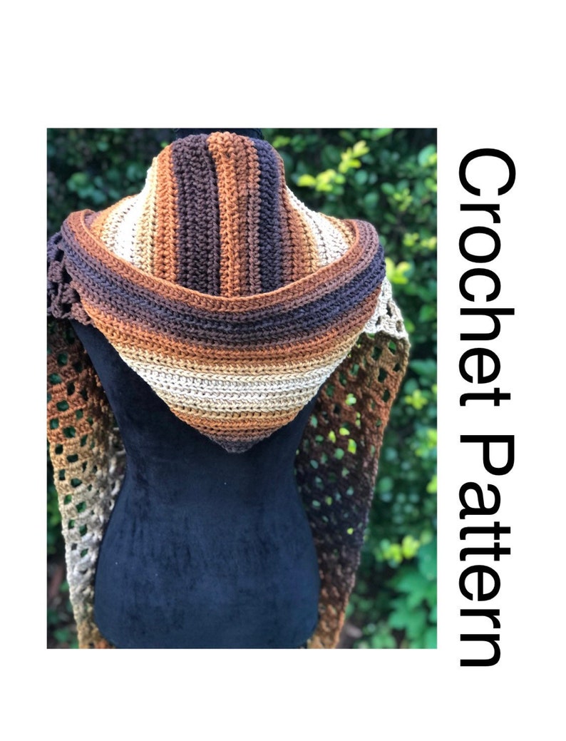 May include: A crocheted hooded scarf in brown, beige, and cream colors. The scarf is made with a lacy stitch pattern and has a wide hood.