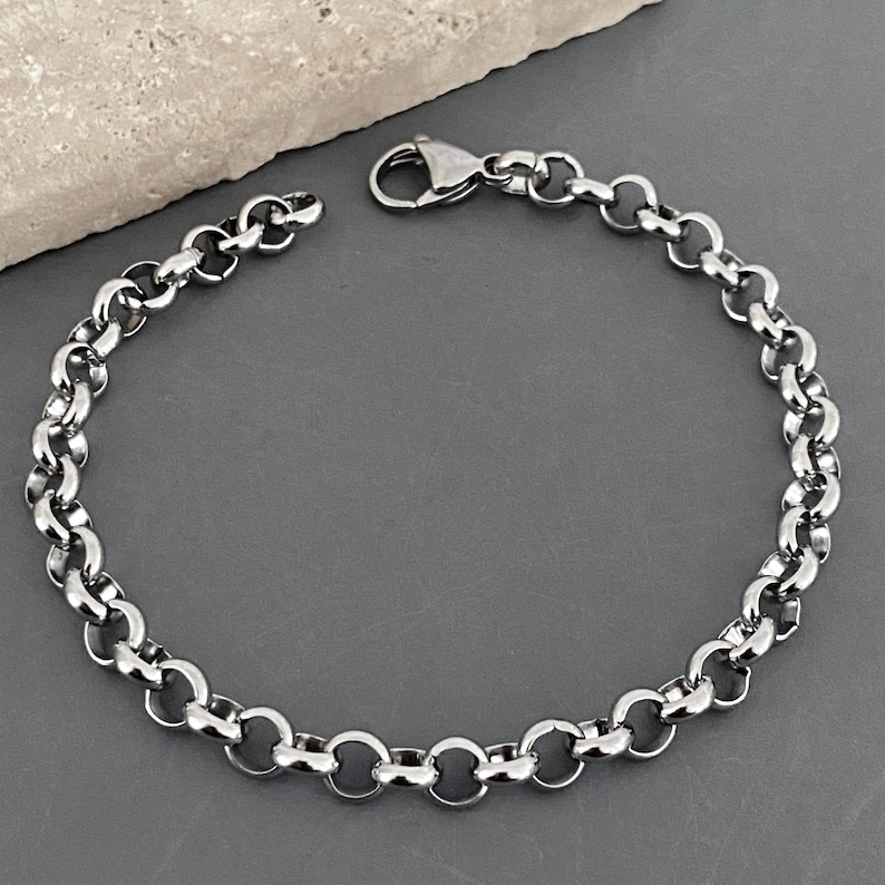 May include: A silver chain bracelet with a lobster clasp fastening.