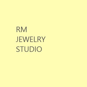 May include: RM Jewelry Studio logo with the text "RM Jewelry Studio" in a grey font on a pale yellow background.