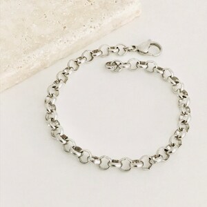 May include: A silver chain bracelet with a lobster clasp closure.