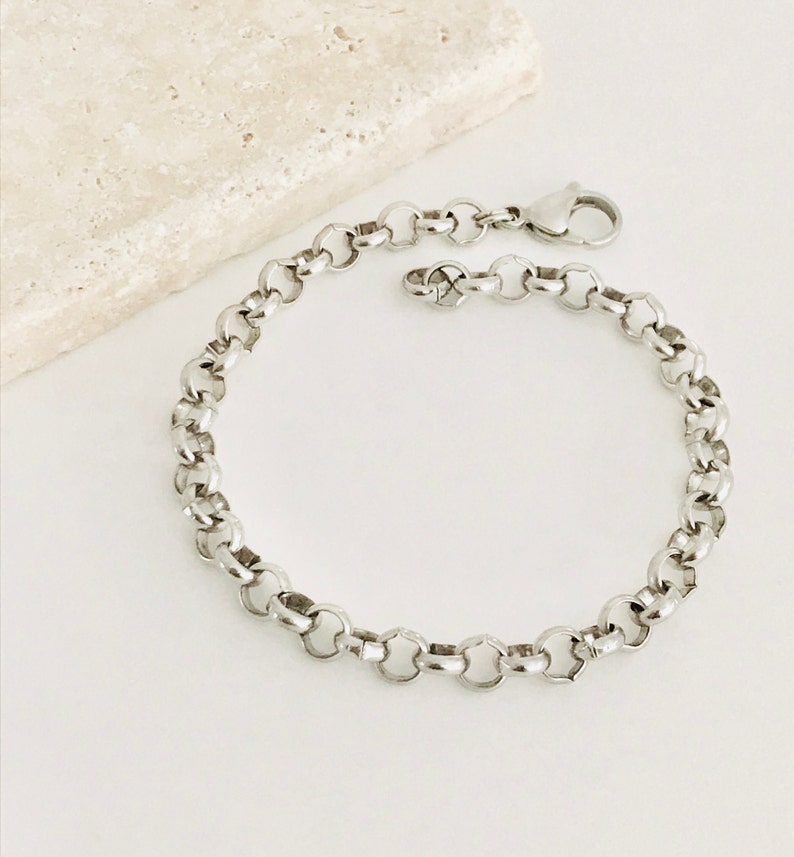 May include: A silver chain bracelet with a lobster clasp closure.