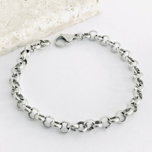 May include: A silver chain bracelet with a lobster clasp.