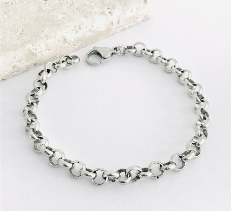 May include: A silver chain bracelet with a lobster clasp.