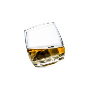 May include: A clear glass with a rounded bottom filled with a golden liquid and a dark ice cube.