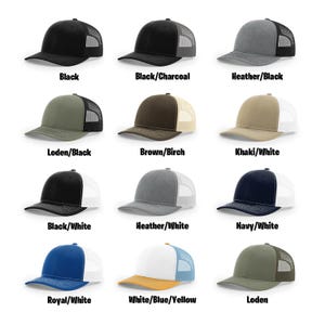 May include: A grid of twelve trucker hats in various colors, including black, heather gray, navy, and khaki. Each hat features a mesh back and a curved brim. Text labels below each hat indicate the color combinations, such as "Black/Charcoal" and "Royal/White".