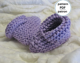 May include: A pair of lavender knitted slipper booties. The booties are made with a simple knit stitch and have a soft, cozy look.
