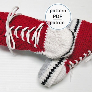 May include: A pair of red and white crocheted slipper shoes shaped like sneakers with white laces. The pattern PDF is included.