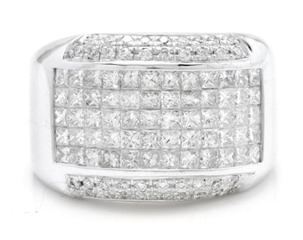 May include: A silver band ring with a large square-shaped center stone surrounded by smaller square-shaped stones. The ring is set with a row of smaller stones on the top and bottom of the band.