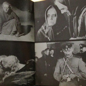 May include: A black and white photo book with four images. The first image shows a woman in a long dress kneeling on the floor. The second image shows two women in traditional clothing. The third image shows a man lying on the floor. The fourth image shows a man in a military uniform standing in front of other men.