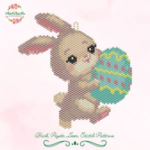 May include: A beaded bunny holding a blue and yellow Easter egg. The bunny is brown and white with black eyes. The egg has a pink, yellow, and blue pattern.