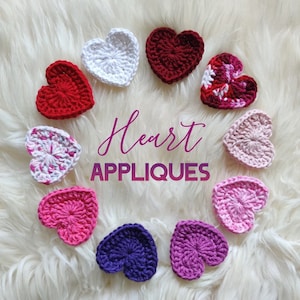 May include: A collection of crocheted heart appliques in various colors, including red, white, pink, and purple, arranged on a fluffy white surface. The image features the text "Heart APPLIQUES" in a decorative font.