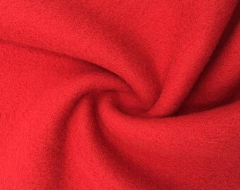 Peut inclure: Un gros plan sur un tissu en polaire rouge vif. Le tissu est doux et texturé, avec un aspect légèrement duveteux.