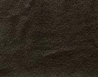 May include: Close-up of a dark brown, textured fabric. The material has a soft, plush appearance with a dense, slightly uneven surface. The color is a deep, neutral brown, suitable for various textile applications.