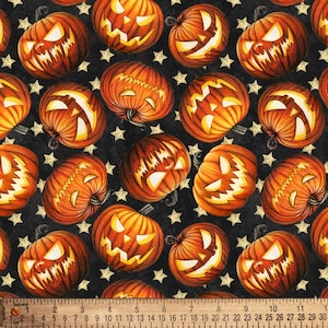 May include: A black background with a repeating pattern of orange jack-o'-lantern pumpkins with various facial expressions. The pumpkins are surrounded by small gold stars.