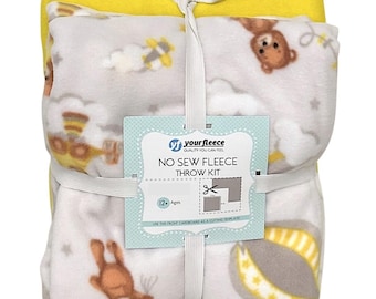 May include: A bundled no-sew fleece throw kit. The kit includes a yellow fleece blanket and a patterned blanket with a repeating design of brown teddy bears, clouds, and stars. The kit is tied with a white ribbon and includes a tag that reads "your fleece NO SEW FLEECE THROW KIT".