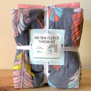 May include: A no-sew fleece throw kit with a gray and pink patterned fleece fabric. The kit includes a cardboard template and instructions for making a 50 x 60 inch throw. The kit is for ages 12 and up.
