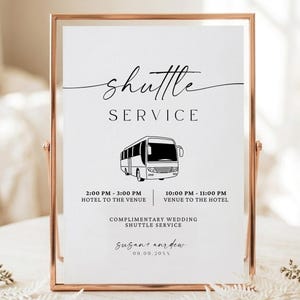 May include: A vertical rectangular sign in a rose gold metal frame featuring black text and a bus graphic. The text reads: shuttle SERVICE, 2:00 PM - 3:00 PM HOTEL TO THE VENUE, 10:00 PM - 11:00 PM VENUE TO THE HOTEL, COMPLIMENTARY WEDDING SHUTTLE SERVICE, susan and andrew, 09.09.20XX.