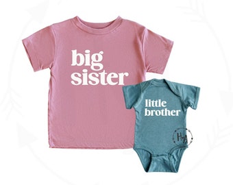 May include: Two shirts, one pink and one teal, with the words "big sister" and "little brother" printed on them.