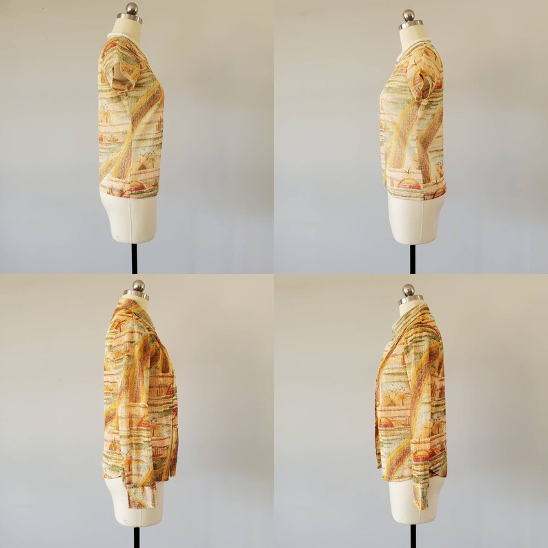 May include: A yellow and orange patterned blouse with a short sleeve and a crew neck. The blouse is on a white mannequin.