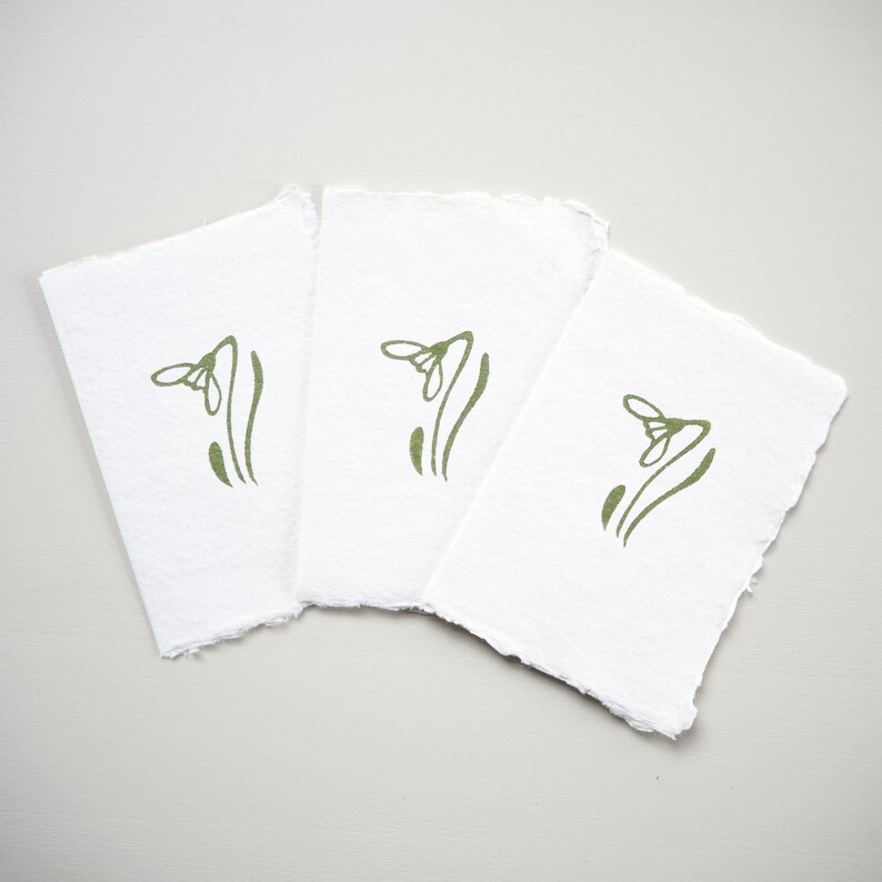 A set of three Lino Printed Snowdrop Gift Cards.