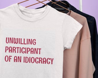 Unwilling Participant of an Idiocracy | Women’s Softstyle Graphic Tee | Funny Sarcastic T-Shirt | Soft & Comfy Casual Shirt