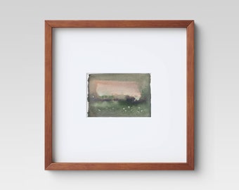 May include: A framed watercolor painting with a brown wooden frame. The artwork features a landscape scene with a muted color palette of green, pink, and brown. The painting is mounted on a white mat.