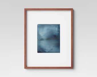 May include: A framed abstract watercolor painting in shades of blue. The painting depicts a hazy, atmospheric scene with a hint of a landscape.