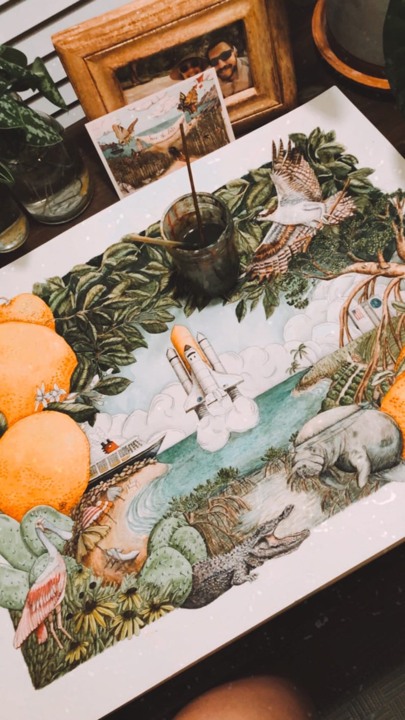 May include: A watercolour painting depicting a variety of Florida wildlife and plants. The painting features a space shuttle launching into the sky, a manatee swimming in the water, an alligator, a pink roseate spoonbill, and a variety of plants, including orange trees, palm trees, and cacti.