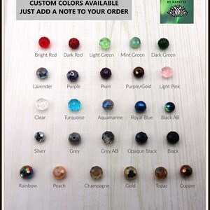 May include: A chart of 20 different colored glass beads, with the name of each color written below the bead. The colors include bright red, dark red, light green, mint green, dark green, lavender, purple, plum, purple/gold, light pink, clear, turquoise, aquamarine, royal blue, black AB, silver, grey, grey AB, opaque black, black, rainbow, peach, champagne, gold, topaz, and copper.