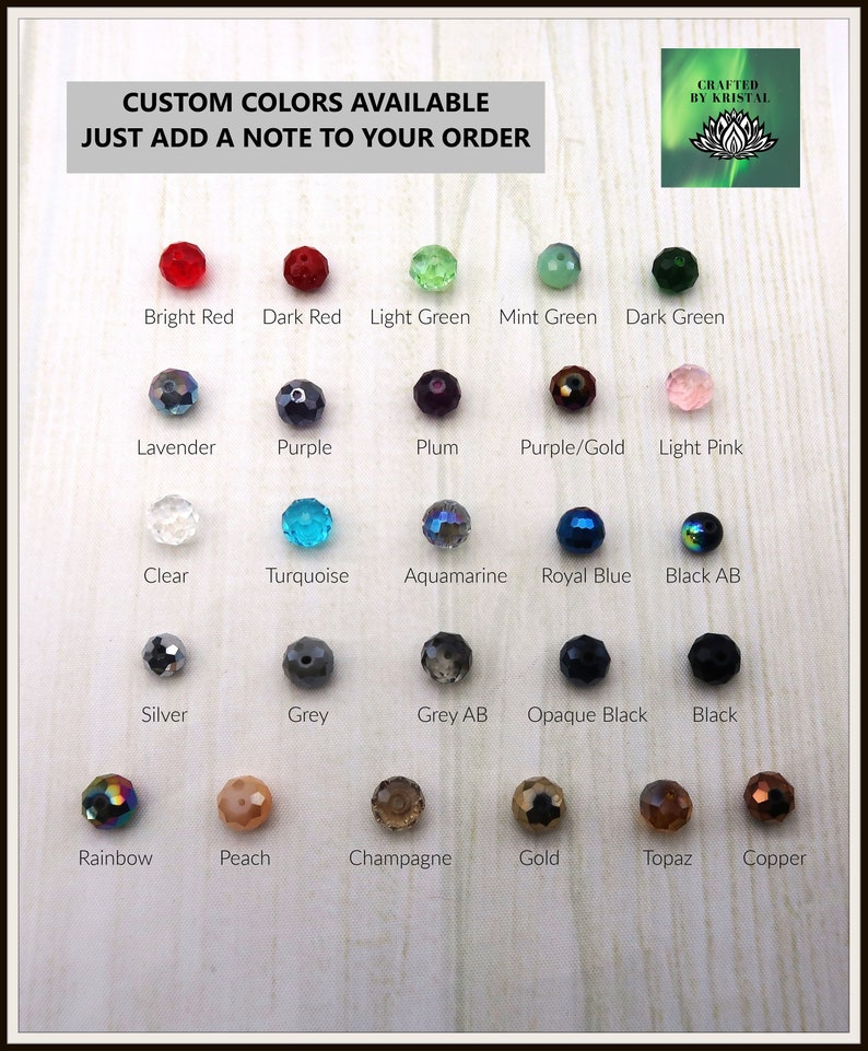May include: A chart of 20 different colored glass beads, with the name of each color written below the bead. The colors include bright red, dark red, light green, mint green, dark green, lavender, purple, plum, purple/gold, light pink, clear, turquoise, aquamarine, royal blue, black AB, silver, grey, grey AB, opaque black, black, rainbow, peach, champagne, gold, topaz, and copper.