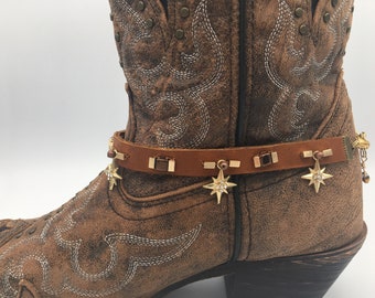 Brown leather boot straps with gold stars