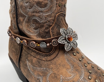 Brown boot strap with flower ornament