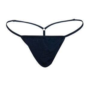 May include: A black thong with thin straps and a ring detail at the back. The thong has a triangular front and adjustable straps for a comfortable fit. The garment is made of a soft, dark fabric.