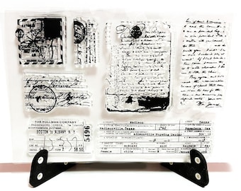 May include: A clear sheet of transparent stamps with black ink. The stamps feature vintage-style designs, including a train ticket, a handwritten letter, and a postal stamp. The text on the stamps includes "The Pullman Company", "Passengers Check", "Boston to Albany, N.Y", "Madisonville, Texas", "adieenville Nursing Center", and "5496".