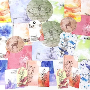 May include: A collection of watercolor paper tags and cards featuring various designs, including butterflies, deer, floral patterns, and abstract watercolor washes. The tags and cards are in shades of blue, green, pink, and yellow.