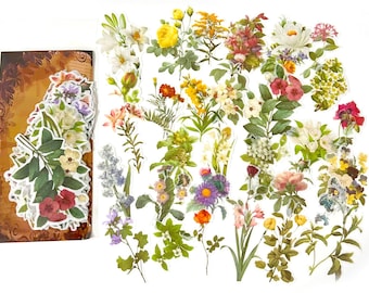 May include: A collection of floral stickers featuring various flowers in shades of white, yellow, red, purple, and green. The stickers are arranged on a white background, with some stickers grouped together on a brown, decorative backing.