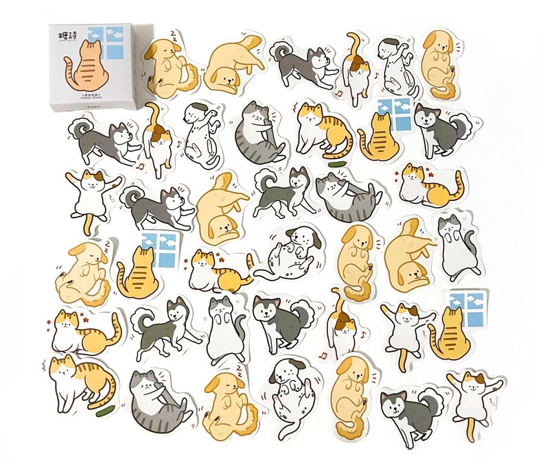 May include: A sheet of stickers featuring various illustrations of cats and dogs in different poses. The stickers are white with black outlines and feature a variety of colors, including yellow, orange, brown, gray, and black. The stickers are perfect for adding a touch of whimsy to journals, planners, laptops, and other surfaces.