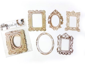May include: A set of six decorative, ornate, gold-toned picture frames with a medieval manor theme. The frames are in various shapes and sizes, including oval, square, and rectangular.