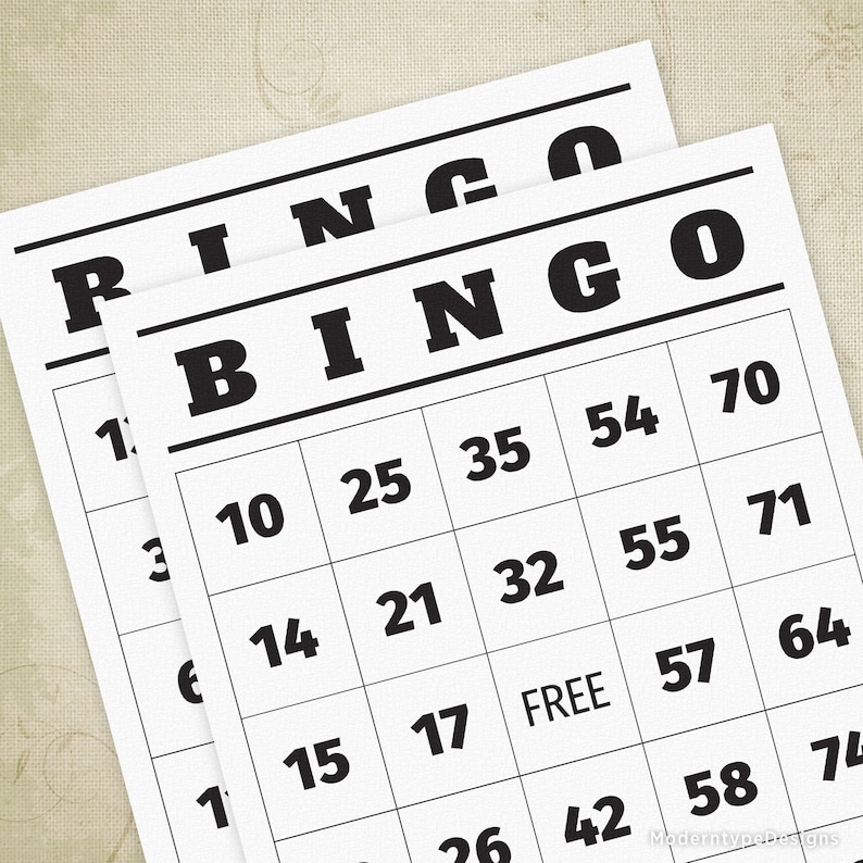 May include: A black and white bingo card with the word "BINGO" at the top and numbers 10, 14, 15, 17, 21, 25, 26, 32, 35, 42, 54, 55, 57, 58, 64, 70, 71, and 74 in the squares. The center square says "FREE".