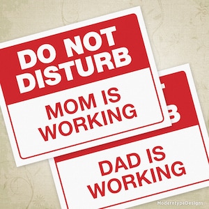 May include: Two red and white signs with the text "Do Not Disturb" and "Mom is Working" on the top sign and "Dad is Working" on the bottom sign.