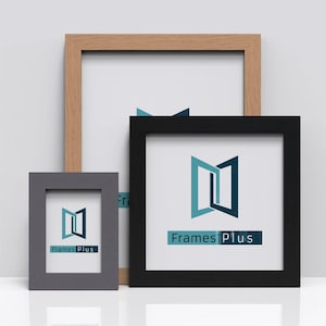 May include: Three picture frames in different sizes and colours. The largest frame is made of light wood and is empty. The middle frame is black and has the text "Frames Plus" in white letters. The smallest frame is grey and also has the text "Frames Plus" in white letters.