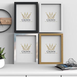 May include: Four picture frames in different colours: black, white, silver, and wood. Each frame features a gold crown logo with the text "CROWN PICTURE FRAMES".