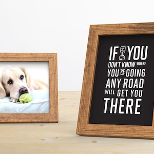 May include: Two wooden picture frames on a wooden table. The frame on the left has a photo of a golden retriever dog with a tennis ball in its mouth. The frame on the right has a black and white print with the text "If you don't know where you're going any road will get you there".