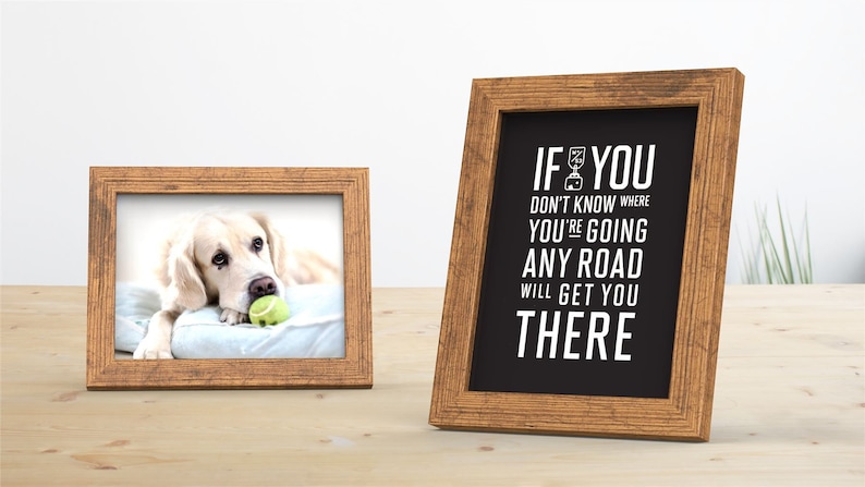 May include: Two wooden picture frames on a wooden table. The frame on the left has a photo of a golden retriever dog with a tennis ball in its mouth. The frame on the right has a black and white print with the text "If you don't know where you're going any road will get you there".